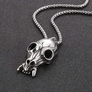 Macro shot of silver punk skull pendant with vintage matte finish on metal chain