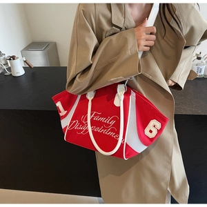 Detail of red canvas bowling bag with embroidery and breathable mesh panels
