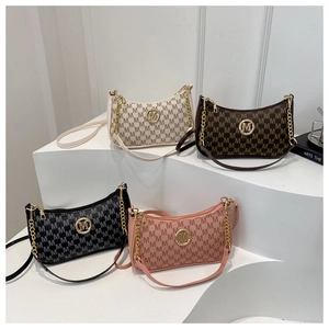 Close-up of four monogram bags with gold chain straps and metal M logo buckles