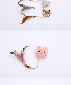 Detail of plush cat toys with bells, feathers and cute animal heads on white background