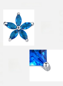 Macro detail of S925 sterling silver flower earrings with blue marquise zircon stones