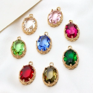 Macro shot of 10x12mm colorful oval birthstone charms with gold claw settings