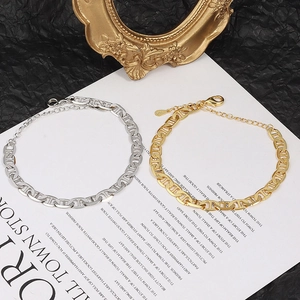 Classic 18K gold and silver plated link bracelets shown with vintage frame and paper