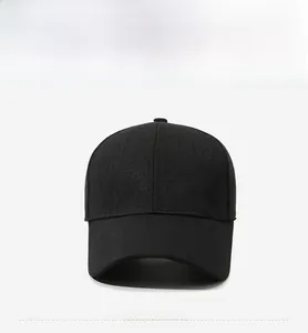 Detail shot of black baseball cap showing textured woven fabric and gold metal logo