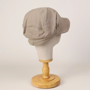 Detailed texture of breathable linen fabric on a beige newsboy cap for spring and summer