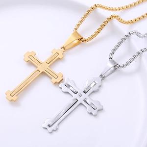 Hip hop stainless steel cross necklace with a single crystal on a white plate
