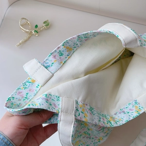 Detail of the cotton canvas tote showing the floral print interior and spacious opening