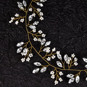 Detailed macro view of bridal hair vine with crystal marquise rhinestones and pearl flowers