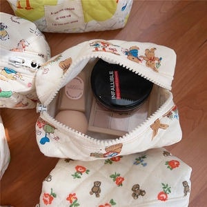 Interior detail of quilted bear makeup bag showing cosmetic storage and soft padded fabric