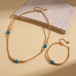 18K gold plated jewelry set with blue turquoise beads and heart charms on a twisted chain