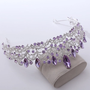 Macro detail of luxury silver bridal crown with purple crystals and sparkling rhinestones