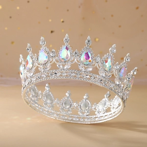 Close-up of silver bridal crown featuring shimmering colorful crystals and drop-shaped gems