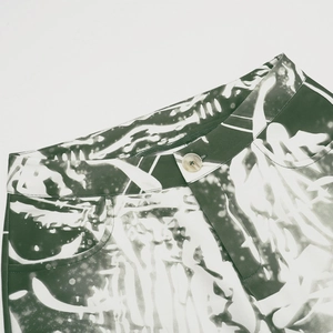 Detailed macro of the marbled button and twill texture on printed street pants