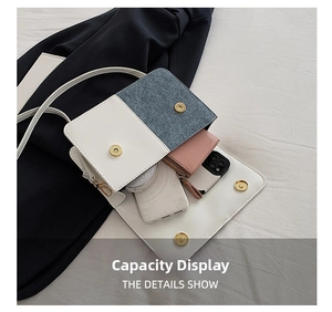 Interior view of white leather and denim crossbody bag showing daily essentials storage