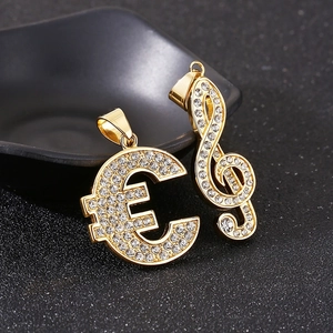 Detail of hip hop gold music note and euro sign pendants with sparkling rhinestone inlay