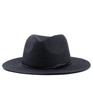 Detailed view of black woven panama straw hat with a matching ribbon and leather accent