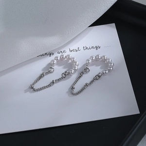 Detailed close-up of pearl tassel clip earrings with silver chain and 8 elegant pearls