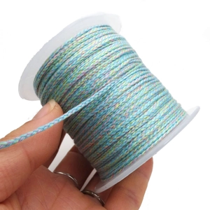 Macro shot of multi-color braided cotton cord roll for DIY jewelry and bracelets