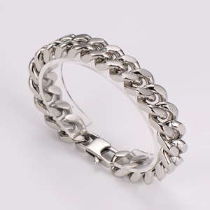 Close-up of silver stainless steel Cuban chain bracelet with mechanical clasp detail