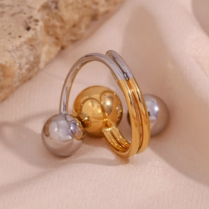 Detail of adjustable two-tone gold and silver ring with spheres on pink silk