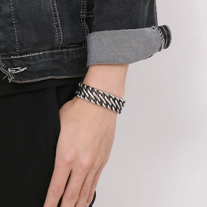 Vintage silver biker bracelet in stainless steel shown on male wrist with denim clothing