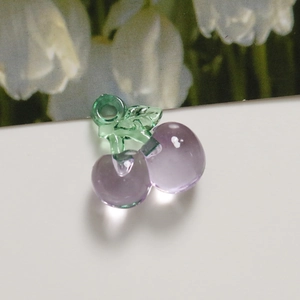 Close-up of translucent purple cherry acrylic pendant charm for DIY jewelry making