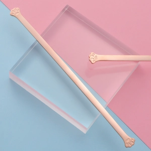 Minimalist rose gold cat paw stainless steel spoons on blue and pink background