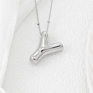 Macro view of 3D bubble letter Y pendant in silver finish with delicate bead chain