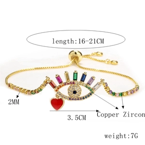Detail of adjustable evil eye bracelet with colorful zircons and red heart charm
