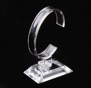 Clear acrylic watch display stand with C-ring holder on a sturdy rectangular base