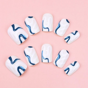 Detail view of short square press-on nails with white and blue fluid wave patterns