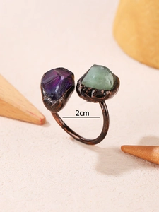 Detailed view of adjustable bronze ring with raw purple amethyst and green fluorite stones