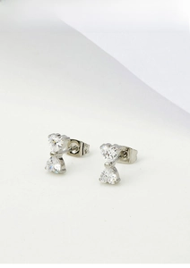 Detailed view of silver titanium steel bow earrings with sparkling white cubic zirconia