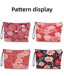 Macro view of four floral rose pattern makeup bags with metal zippers and wrist straps