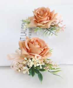 Detailed view of champagne artificial rose corsage and wrist flower with silk ribbons