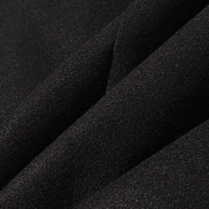 Detailed macro view of black textured tweed fabric showing high-quality fiber weave