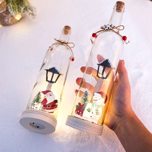 Christmas LED glass wish bottle with Santa and Snowman figures on wooden base
