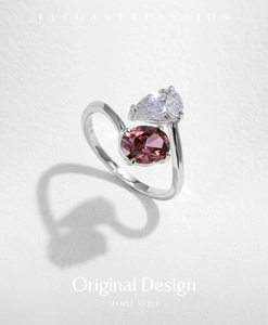 Macro view of S925 silver ring featuring intertwined clear and purple teardrop crystals