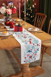 Close-up of festive Christmas table runner with reindeer and snowflake print on wood table