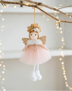 Close-up of handmade angel girl ornament with pink mesh dress and gold glitter wings