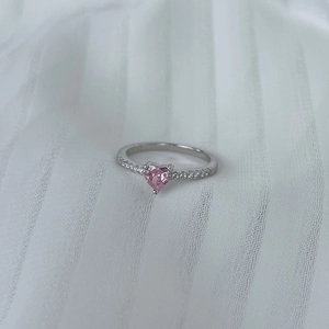 Macro detail of S925 silver ring featuring a pink heart stone and zircon pavé band
