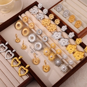 Vintage geometric gold plated earrings set with pearl details in a velvet jewelry box
