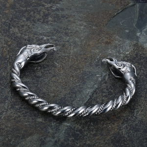 Macro shot of vintage Viking open cuff bracelet with dual dragon head carving on stone