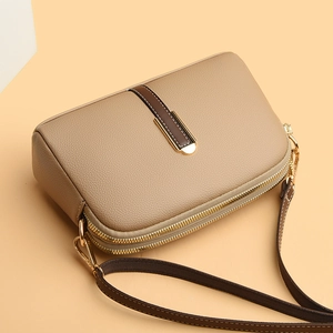 Beige PU leather shell shoulder bag with double zippers and dark brown strap
