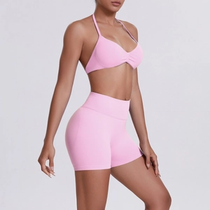 Detail of pink halter sports bra and high-waist shorts set with ribbed texture