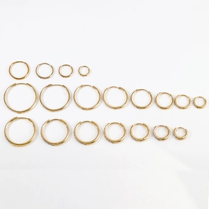 Detailed size comparison of gold stainless steel hoop earrings with engraved textures
