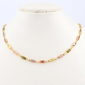 Detailed view of a gold-plated necklace with colorful rectangular cubic zirconia crystals