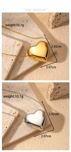Detail of heart pendant showing dimensions 2.92cm x 2.97cm and weight 10.7g on stone base