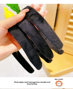 Detail showing high flexibility and soft plush texture of the black vegetable headband