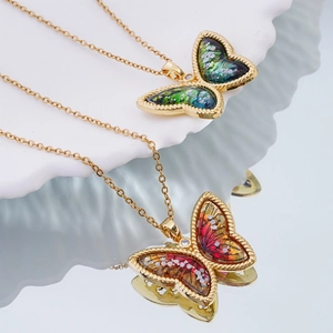 Exquisite 18K gold plated butterfly necklaces with vibrant gradient wings on ceramic tray
